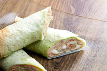 spinach tortilla filled with salmon and mozzarella