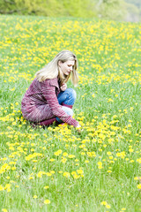 woman sitting on spring meadow