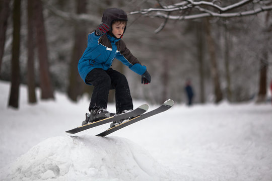 Little boy skier on ski-jump