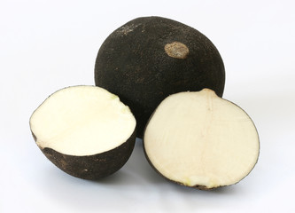 Cut black radish halves on grey background