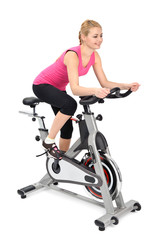 young woman doing indoor biking exercise