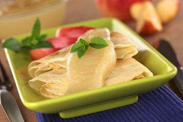 Crepes with apple sauce (Selective Focus, Focus on the mint)