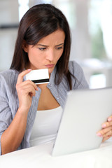 Young woman doing online shopping with tablet