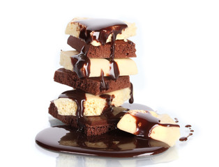Slices of milk and white chocolate bar poured chocolate isolated