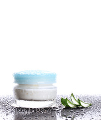 Closed glass jar of cream and aloe