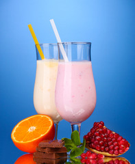 Milk shakes with fruits and chocolate on blue background