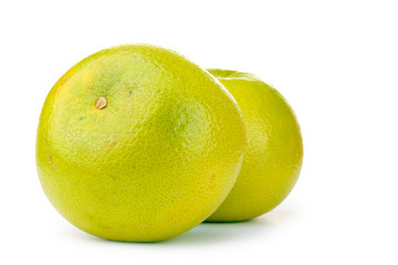 two green grapefruits isolated on white