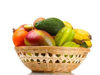 Assortment of exotic fruits in basket isolated on white