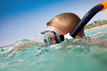 boy floats in the red sea