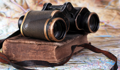 Old binocular with antique book