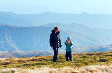 Fototapeta na wymiar Family make photo on autumn mountain plateau