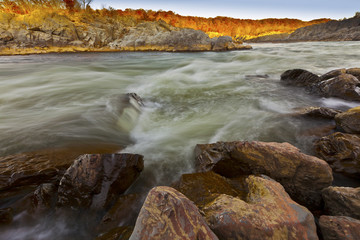 White water river and rocks in sunset light