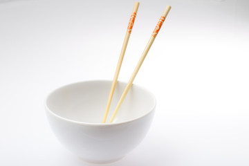 white bowl with chopsticks