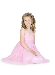 The girl in a pink dress on a white background