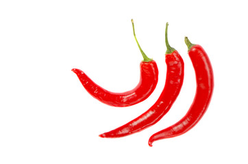 Three thin elongated hot red chili pepper isolated