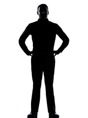 one business man standing hands on hips silhouette
