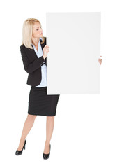 Cheerful businesswoman presenting empty board