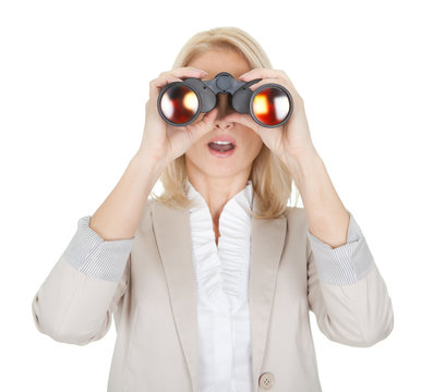 Businesswoman looking through binoculars