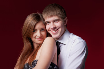 couple embracing on the red background