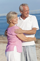 Fototapeta na wymiar Happy Senior Couple Embracing on Beach