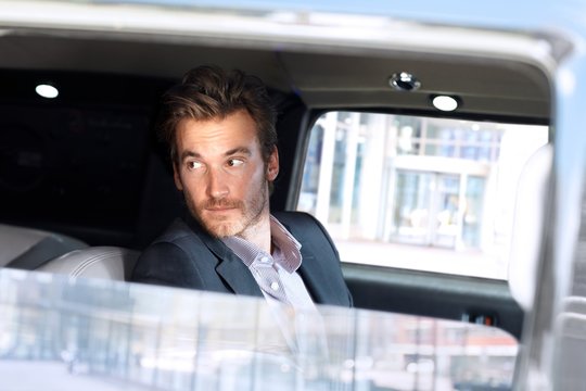 Young Man Looking Out Of Limousine Window