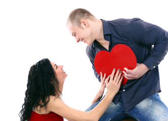 Young couple with a heart over white background