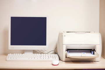 keyboard mouse and printer on desk
