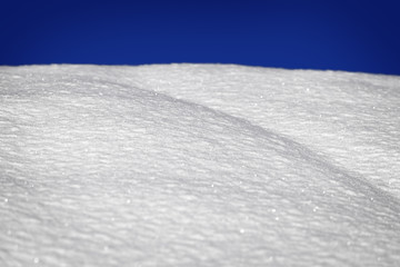 Snow texture with horizon and blue sky