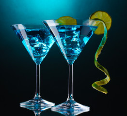 Blue cocktail in martini glasses on blue background