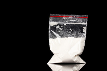 Cocaine in package on black background