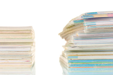 two stacks of magazines isolated on white