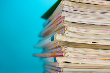 stack of magazines on blue background
