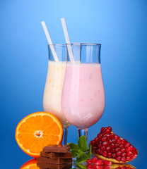 Milk shakes with fruits and chocolate on blue background