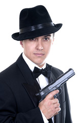 Man in suit draws vintage handgun