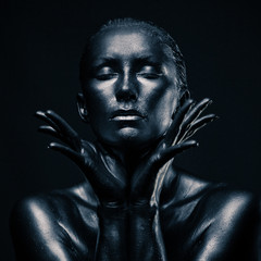 Nude woman like statue in liquid metal