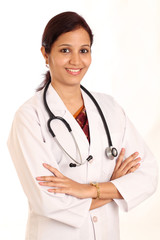Cheerful young female doctor with crossed arms