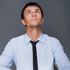 Portrait of an adult business man sitting in the office and dayd