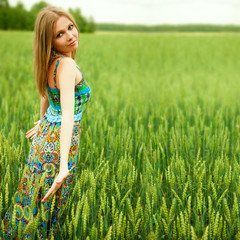 Young happy woman in field