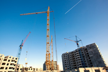 Construction site with tower cranes in evening