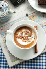 Cappuccino for Breakfast with newspaper and blue tea towel