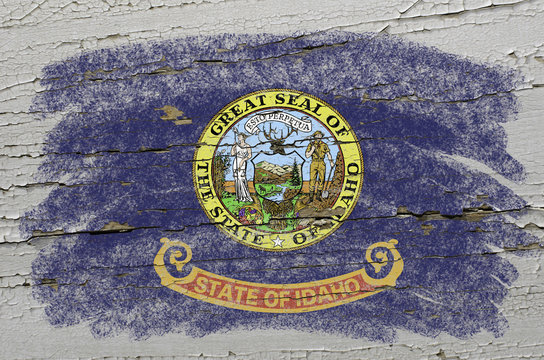 flag of US state of idaho on grunge wooden texture precise paint