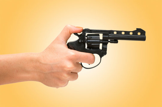 Hand holding revolver isolated on the white