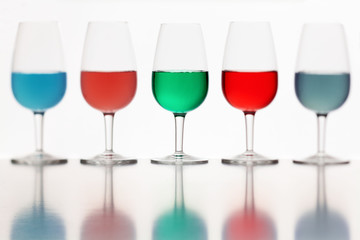 defocused glasses of colored liquid