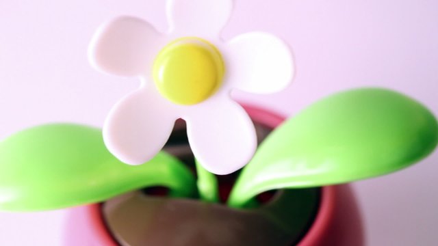 Clockwork toy flower tilts from one side to another