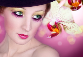 Bright make-up of eyes and orchid flower