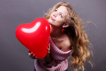 Valentines day woman holding red heart balloon