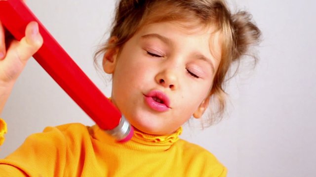 Little girl hold big pencil and smile
