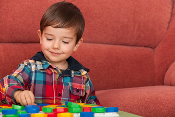 Little boy playing at the table