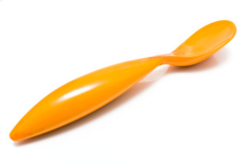 Orange plastic spoon