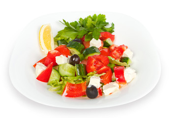 fresh Greek salad in white bowl